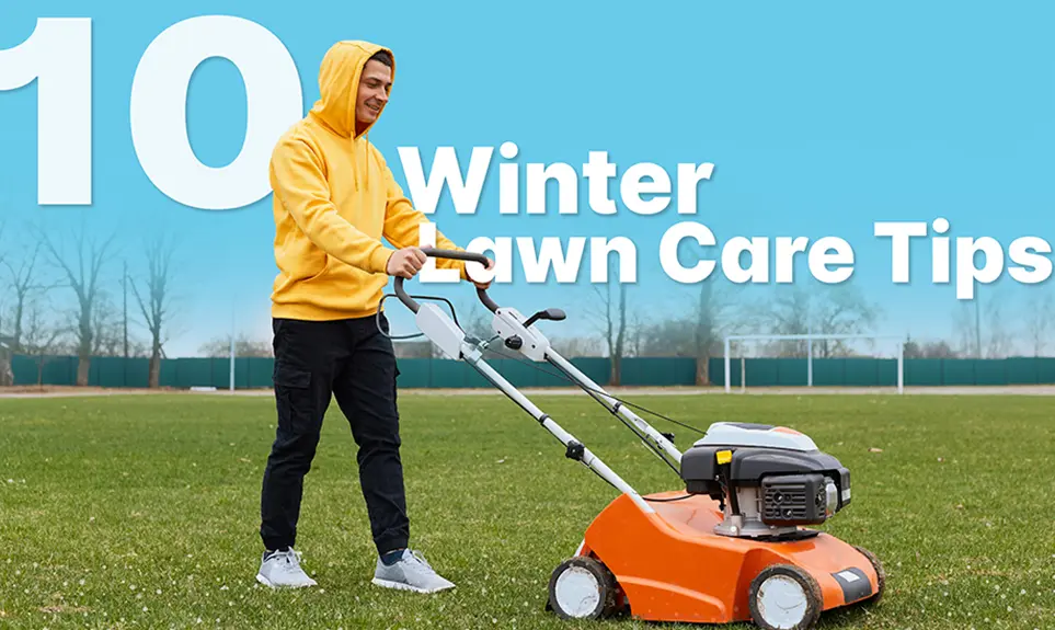 Man in yellow hoodie pushing an orange lawn mower across a green field on a clear day