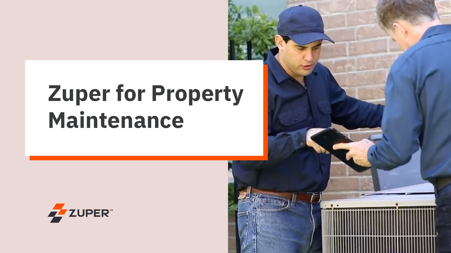 Technician in navy uniform showing tablet to colleague while servicing outdoor HVAC unit at residential property