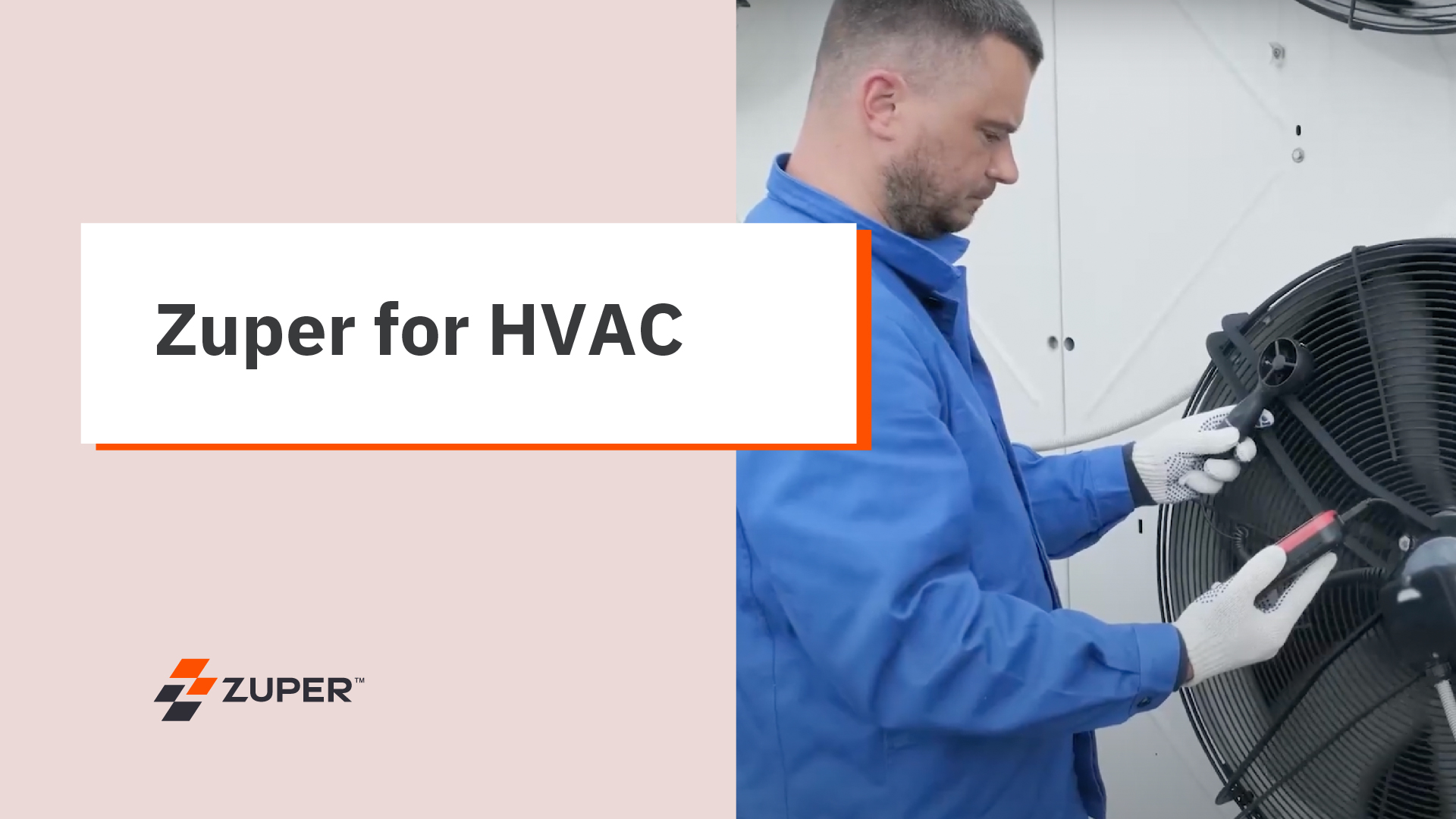 HVAC technician in blue coveralls servicing an outdoor condenser unit fan
