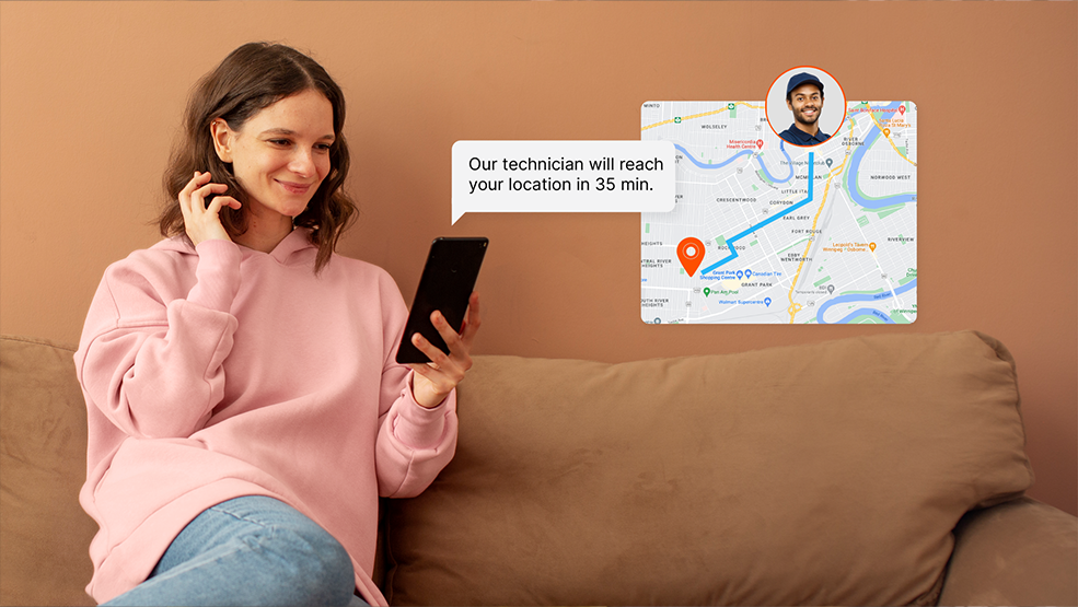 Woman on couch viewing phone notification showing technician ETA and live GPS tracking on a map