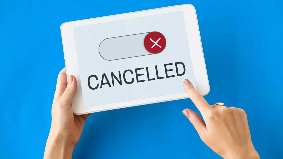 Tablet displaying a toggle switch set to cancelled with an X icon, indicating subscription or service cancellation