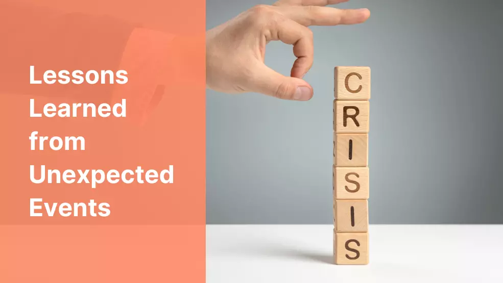 Hand reaching to topple stacked wooden blocks spelling CRISIS, representing crisis management and business preparedness