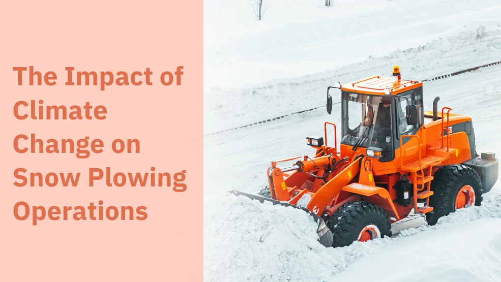 Orange wheel loader with snow plow attachment clearing snow from a road during winter operations