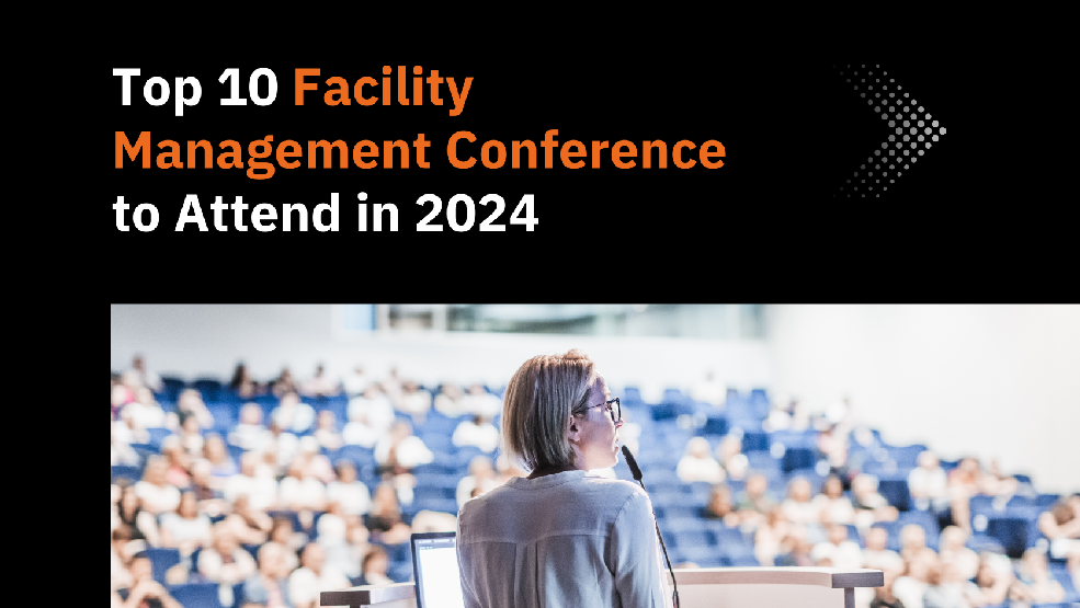 Woman presenting to a large audience at a facility management conference in a modern lecture hall