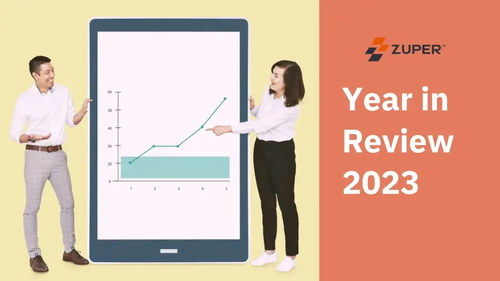 Zuper 2023 Year in Review showing two professionals presenting a growth chart on a large tablet display