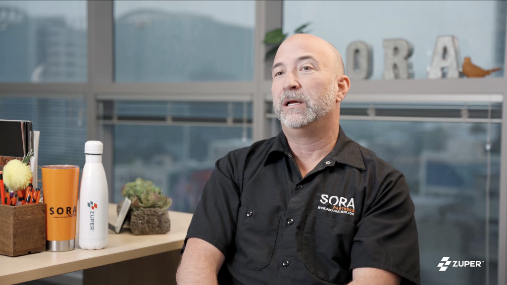 Sora Partners representative discussing Zuper field service management software in office testimonial video