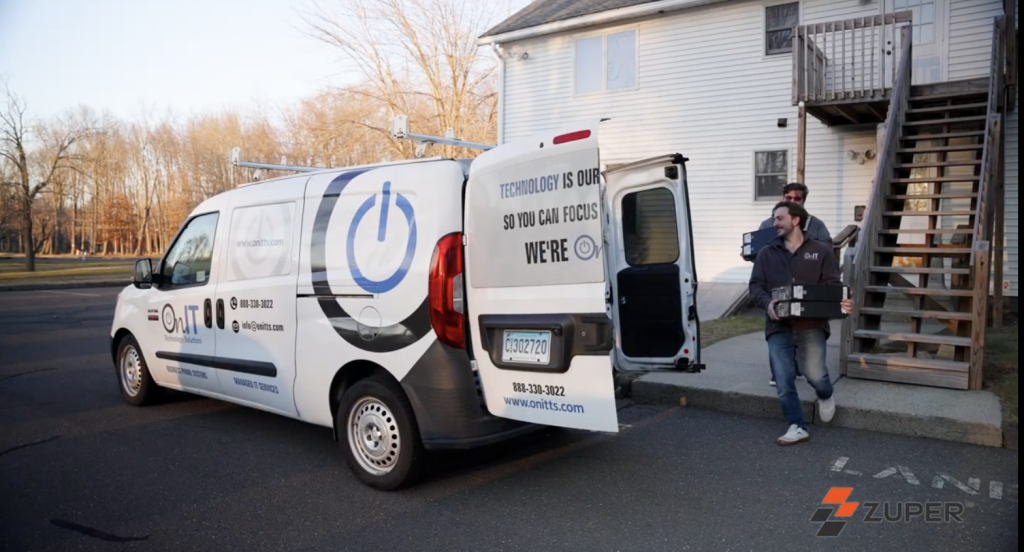 OnIT Technology Solutions service van with technician unloading IT equipment at a residential job site